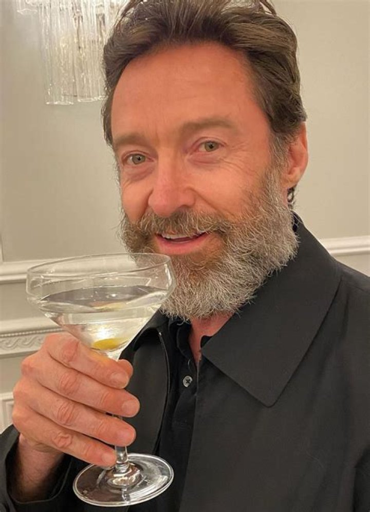 Hugh Jackman holding a martini glass with his wife Deborra-Lee Furness