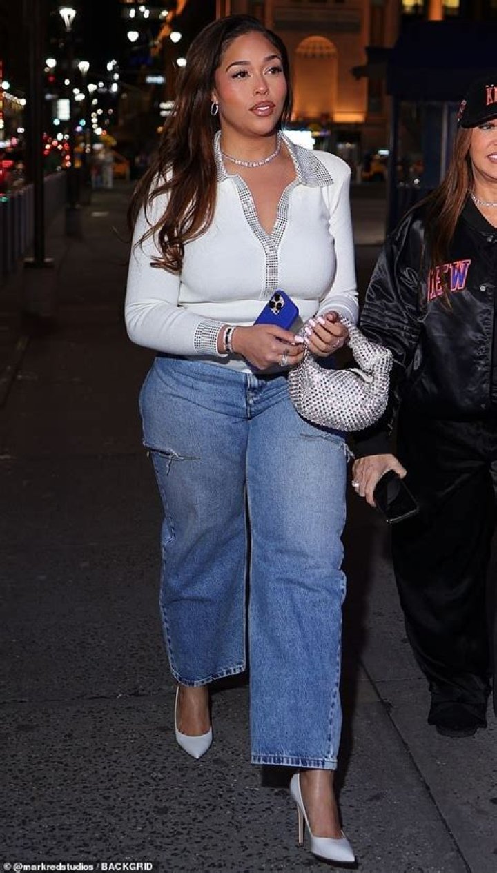 Still chic: She flaunted her incredible physique as she slipped into a skintight checked racing suit while pushing herself around a makeshift track