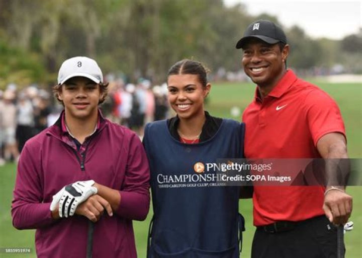 Tiger Woods poses with his daughter, Sam, son, Charlie and girlfriend Erica Herman after the World Golf Hall of Fame Induction Ceremony prior to THE PLAYERS Championship at PGA TOUR Global Home on March 9, 2022, in Ponte Vedra Beach, FL.